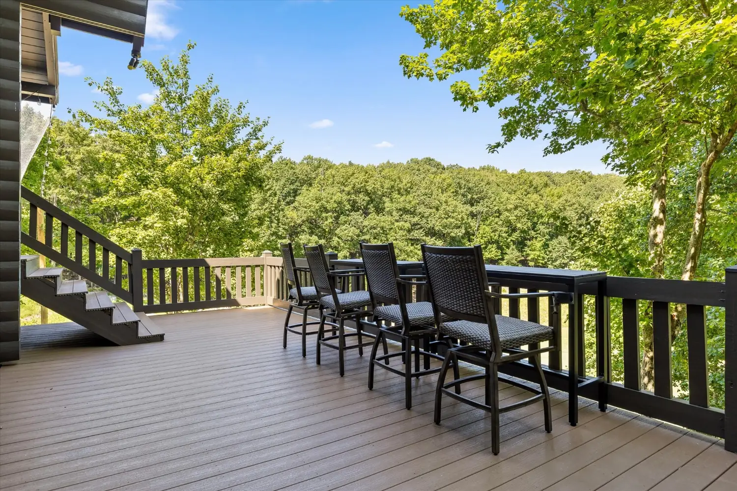 Long outdoor dining table on the covered deck