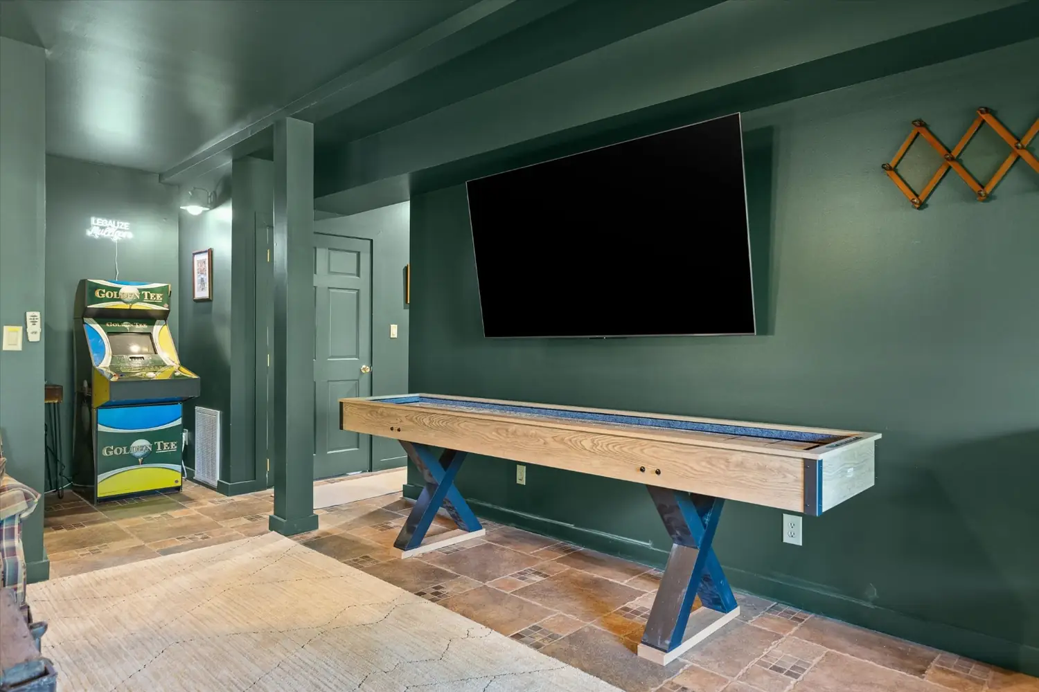 Full-length shuffleboard table in the lower-level game room
