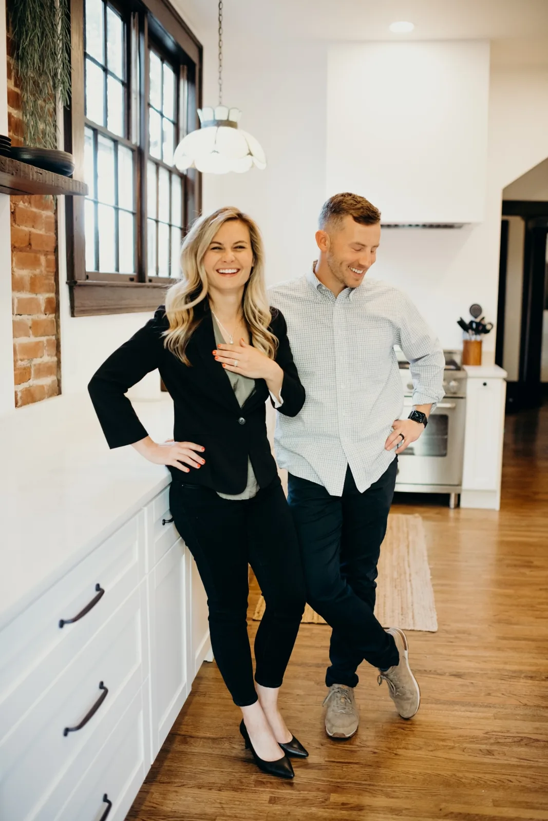 Jeff and Chelsea Musser laughing together in a bright kitchen